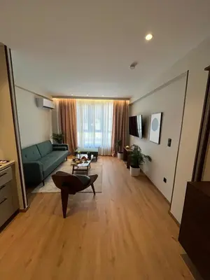 a living room with a green couch and a table at Psiri 48 Boutique Suite in Athens