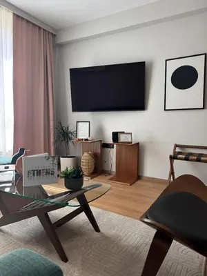 a living room with a flat screen tv on the wall at Psiri 48 Boutique Suite in Athens