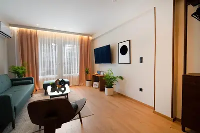 a living room with a blue couch and a chair at Psiri 48 Boutique Suite in Athens