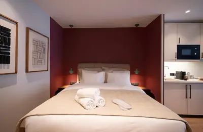 a bedroom with a large bed with towels on it at Psiri 48 Boutique Suite in Athens