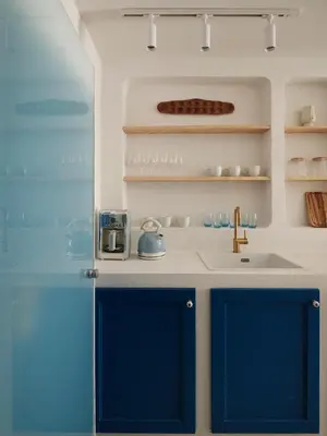 a kitchen with blue cabinets and a sink at Athens Cycladic Hideaway in Athens