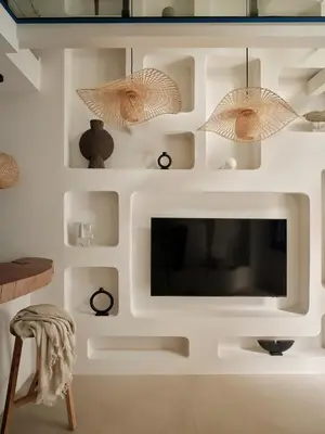 a living room with a tv in a white wall at Athens Cycladic Hideaway in Athens