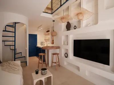 a living room with a large flat screen tv on a wall at Athens Cycladic Hideaway in Athens