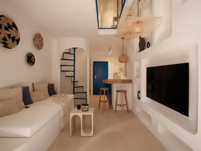 a living room with a white couch and a tv at Athens Cycladic Hideaway in Athens