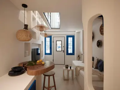 a kitchen and living room with blue and white walls at Athens Cycladic Hideaway in Athens