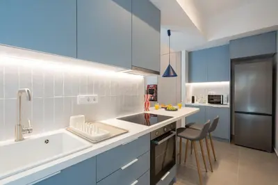 a kitchen with a sink and a refrigerator at 1BR Next to Metro Modern Living & Arcade Machine in Athens