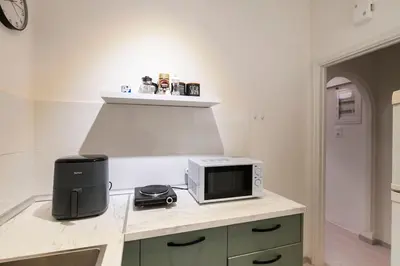 a kitchen with a counter with a microwave on it at Athens Retreat Paleo Faliro,Onassis,REA Hospital in Athens