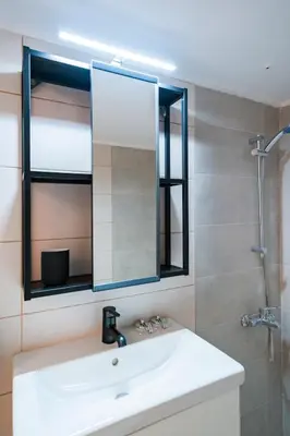 a bathroom with a sink and a mirror at Athens Retreat Paleo Faliro,Onassis,REA Hospital in Athens