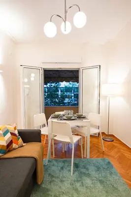 a living room with a white table and chairs at Athens Retreat Paleo Faliro,Onassis,REA Hospital in Athens