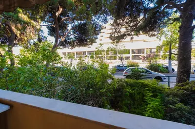 a building with cars parked in a parking lot at Athens Retreat Paleo Faliro,Onassis,REA Hospital in Athens