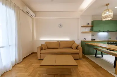 a living room with a couch and a table at Nea Smyrni Square Appartment in Athens
