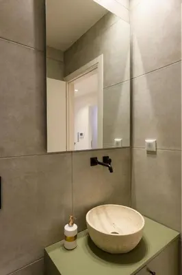 a bathroom with a sink and a mirror at Nea Smyrni Square Appartment in Athens