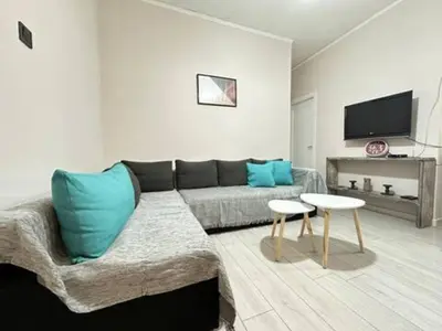 a living room with a couch and a table at Votanikos Urban Nook, Athens in Athens