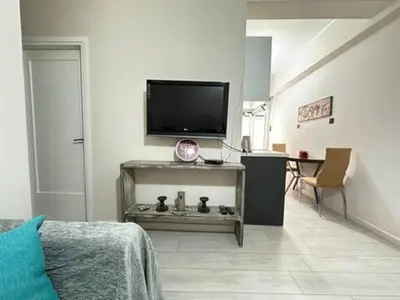 a living room with a flat screen tv on a wall at Votanikos Urban Nook, Athens in Athens