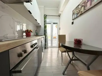 a kitchen with a table and a counter top at Votanikos Urban Nook, Athens in Athens