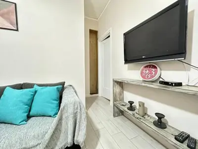 a living room with a flat screen tv on the wall at Votanikos Urban Nook, Athens in Athens