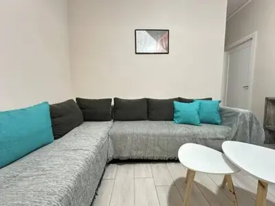 a living room with a couch and a table at Votanikos Urban Nook, Athens in Athens