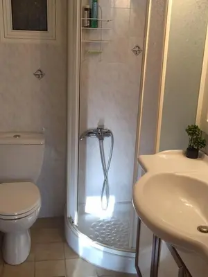 a bathroom with a shower with a toilet and a sink at Villa Agia Marina 5m walk to the beach with private pool in Aghia Marina