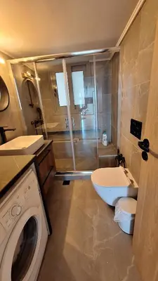 a bathroom with a shower and a washing machine at Vip Panoramic view in Athens