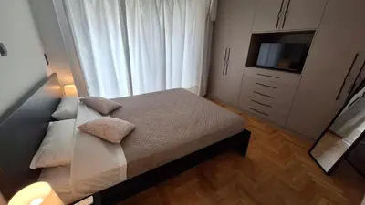 a small bedroom with a bed and a television at Vip Panoramic view in Athens