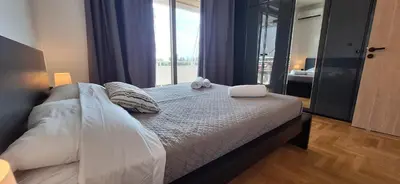 a bedroom with a bed with two stuffed animals on it at Vip Panoramic view in Athens