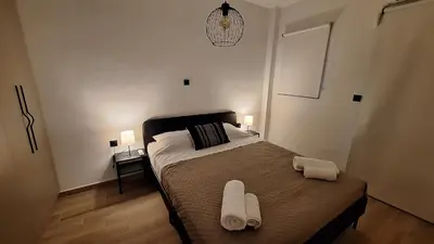 a bedroom with a bed with two white towels on it at Vip Panoramic view in Athens