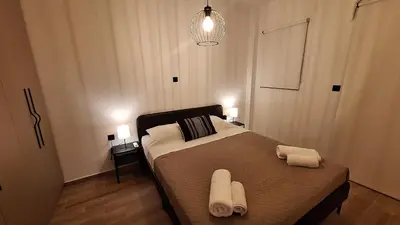 a bedroom with a bed with two towels on it at Vip Panoramic view in Athens