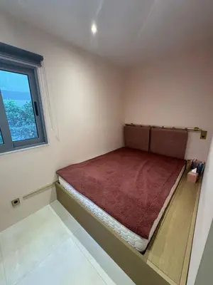 a bed in a room with a window at Cosy apartment with shared pool and garden in Athens