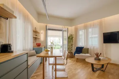 a kitchen with a table and a living room at Koukaki Cityscape in Athens