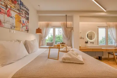 a bedroom with a large bed and a bathroom at Koukaki Cityscape in Athens