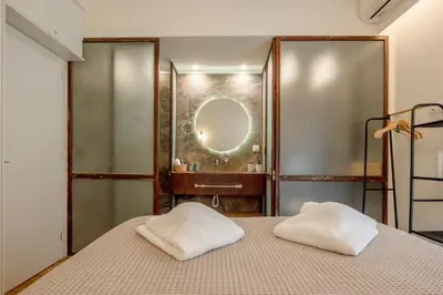 a bedroom with a bed and a mirror at Koukaki Cityscape in Athens
