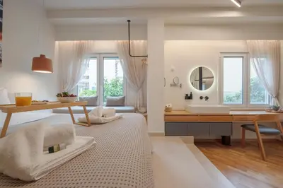 a living room with a desk and a table with a sink at Koukaki Cityscape in Athens