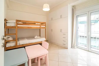 a bedroom with bunk beds and a desk and a table at Azotea Con Vista Athens in Athens