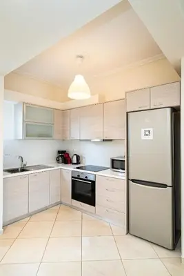 a kitchen with white cabinets and a refrigerator at Azotea Con Vista Athens in Athens