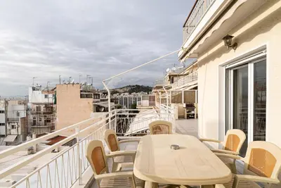 a balcony with a table and chairs on a building at Azotea Con Vista Athens in Athens