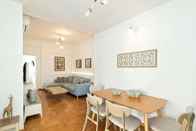a living room with a table and a couch at Altezza Terrazza Athens in Athens