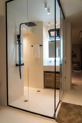 a glass shower in a bathroom with a sink at Aura Vista Acropolis view in Athens