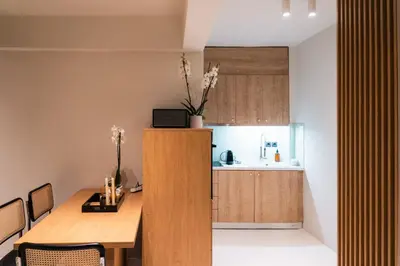 a kitchen and dining room with a wooden table at Aura Vista Acropolis view in Athens