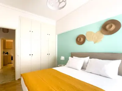 a bedroom with a bed with a blue wall at Belita large 1BR close to the Acropolis in Athens