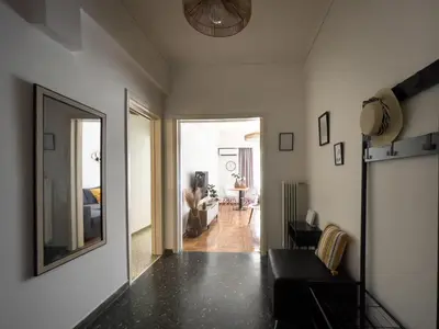 a living room with a mirror on the wall at Belita large 1BR close to the Acropolis in Athens