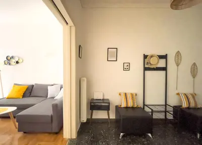 a living room with a couch and a table at Belita large 1BR close to the Acropolis in Athens