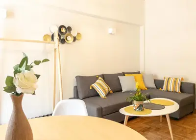 a living room with a couch and a table at Belita large 1BR close to the Acropolis in Athens