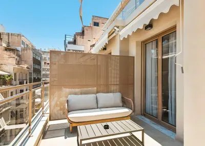 a balcony with a couch and a table at Limehome Piraeus Iris in Piraeus