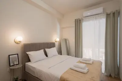 a bedroom with a large white bed with towels on it at Acropolis Retreat Walk to Museum in Athens