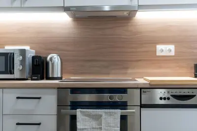 a kitchen with a stove and a microwave at Acropolis Retreat Walk to Museum in Athens