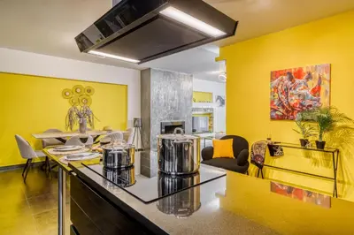 a kitchen with yellow walls and a counter with two coffee pots at Two bedroom Lux apartment Next to the metro in Athens