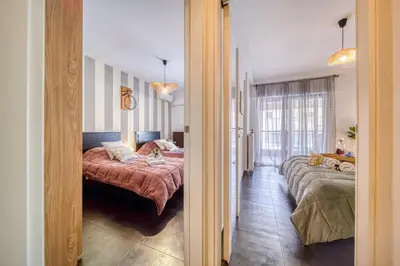 a bedroom with two beds and a hallway at Two bedroom Lux apartment Next to the metro in Athens
