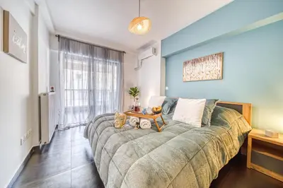 a large couch in a room with a large window at Two bedroom Lux apartment Next to the metro in Athens