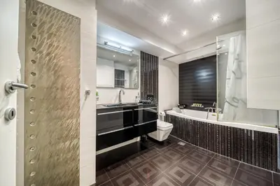 a bathroom with a tub and a toilet and a sink at Two bedroom Lux apartment Next to the metro in Athens