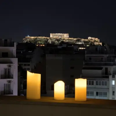 a view of the acropolis at night with lit up candles at Acropolis Panorama Luxury Loft 8th fl Balcony View in Athens